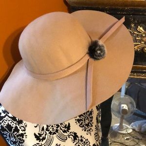 Tan hat with furry accent on the side.